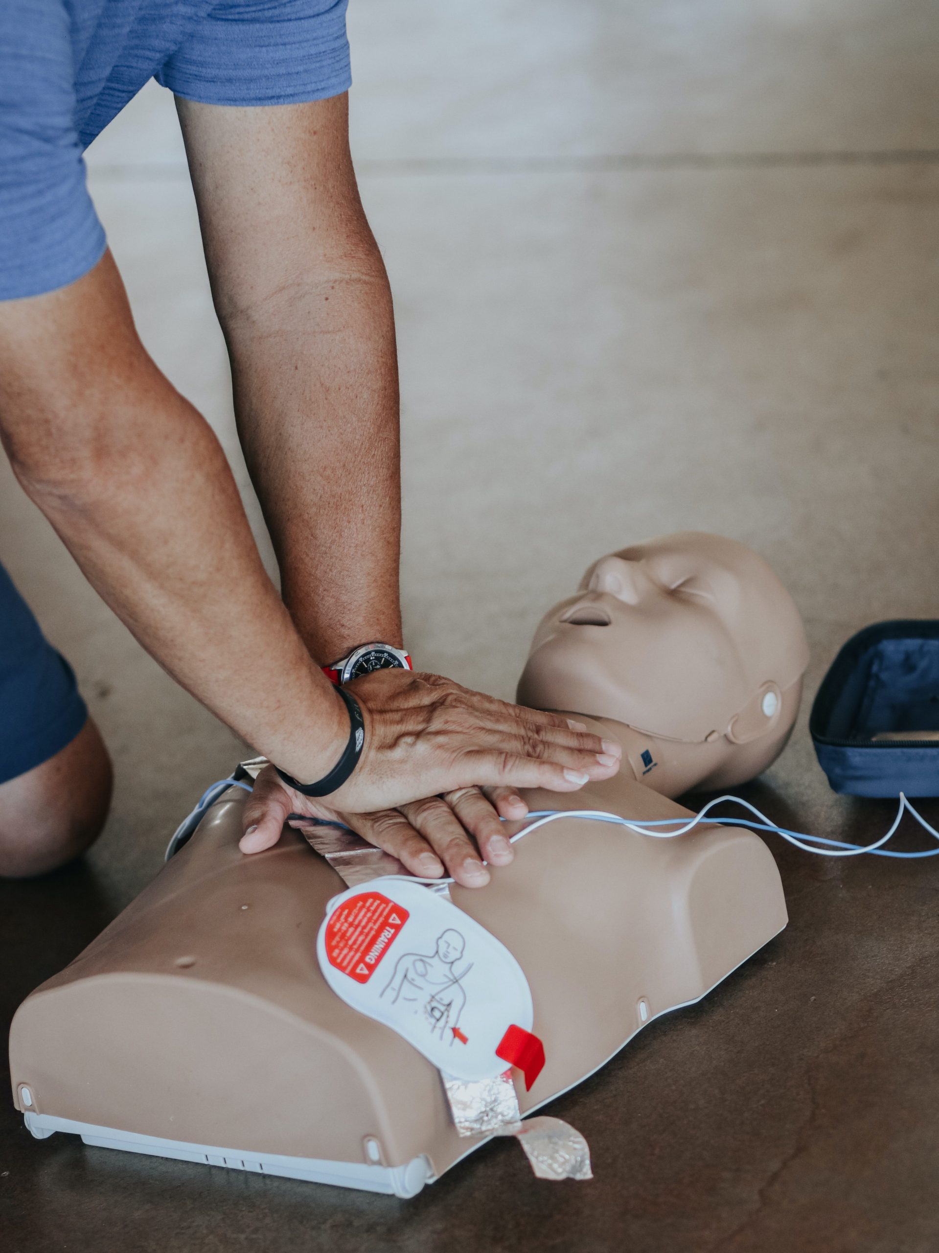 Man performing CPR on training dummy