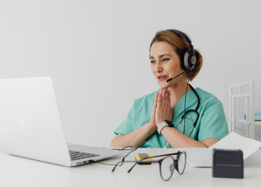 Medical professional in green scrubs on tele-health call